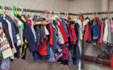 Children's clothes on sale in a second hand store.