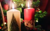 White and red candle in Christmassy setting.