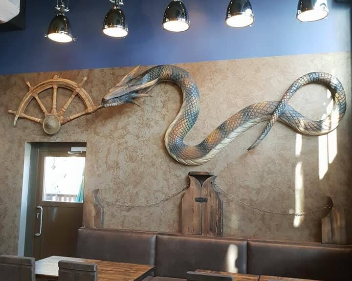 Gastrobar Wanha Krouvi's snake decoration on the wall.