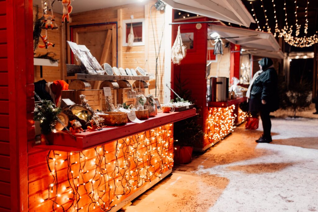 Christmas Market booths in Rauma. A customer in front of a booth.