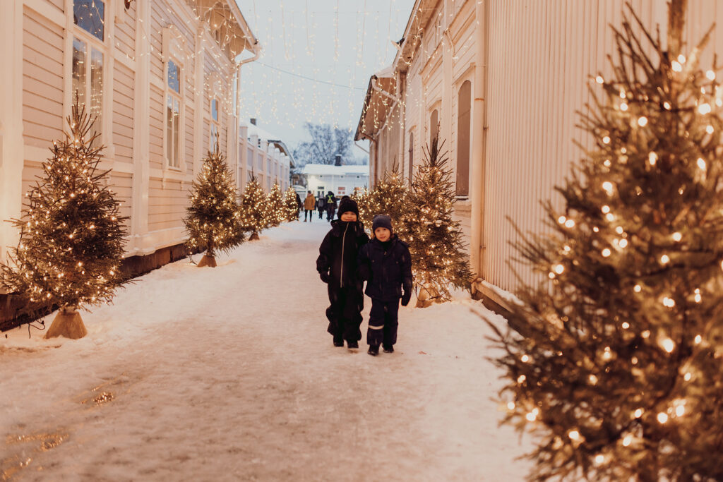 Children walking in the Christmas tree alley.