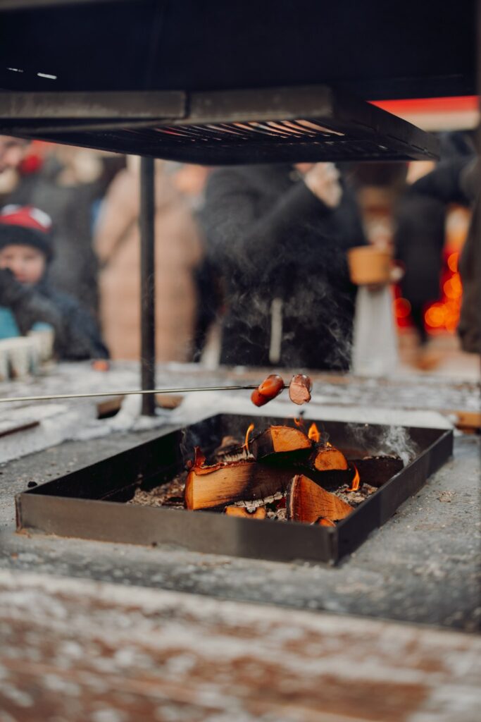 Sausage roasting in the fireplace of Rauma Christmas Market.