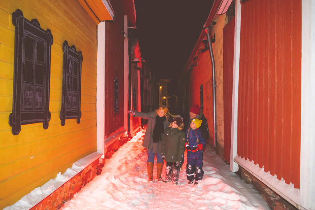 A family looking at the smallest Christmas street in Finland art work in Old Rauma.