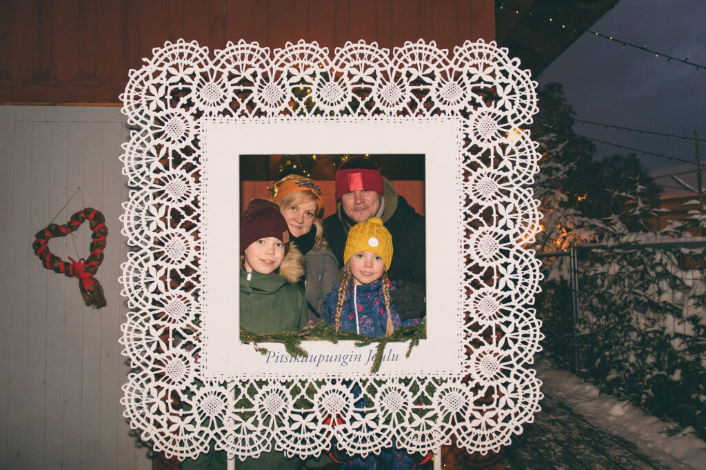 Family photo with Christmas in Lace Town frames.