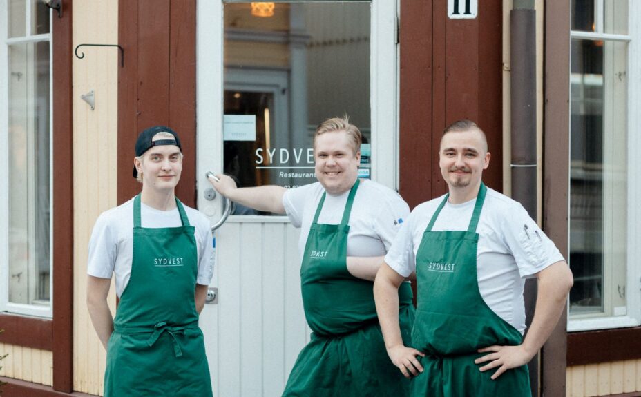 Restaurant Sydvest's staff in front of the restaurant's entrance.