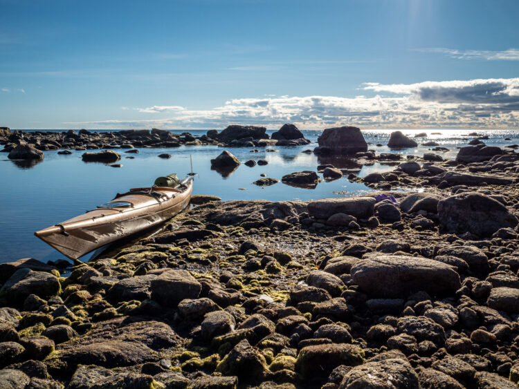 The rocky shore of Nurmes island, canoe at the side of the picture.