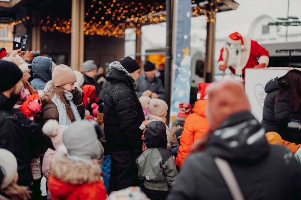 Audience in front of the stage of Rauma Christmas Market. Santa Claus on stage.
