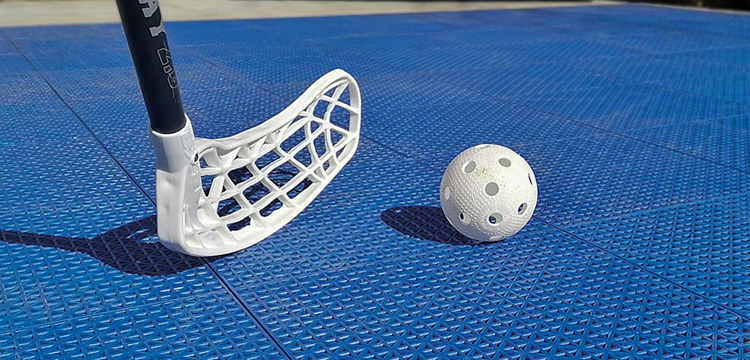 Floorball stick and ball.