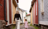 A woman and a child walking in Kitukränn, the narrowest street in Finland.