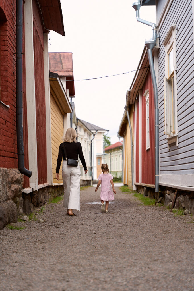 A woman and a child walking in Kitukränn, the narrowest street in Finland.