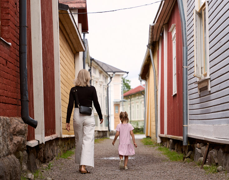 A woman and a child walking in Kitukränn, the narrowest street in Finland.