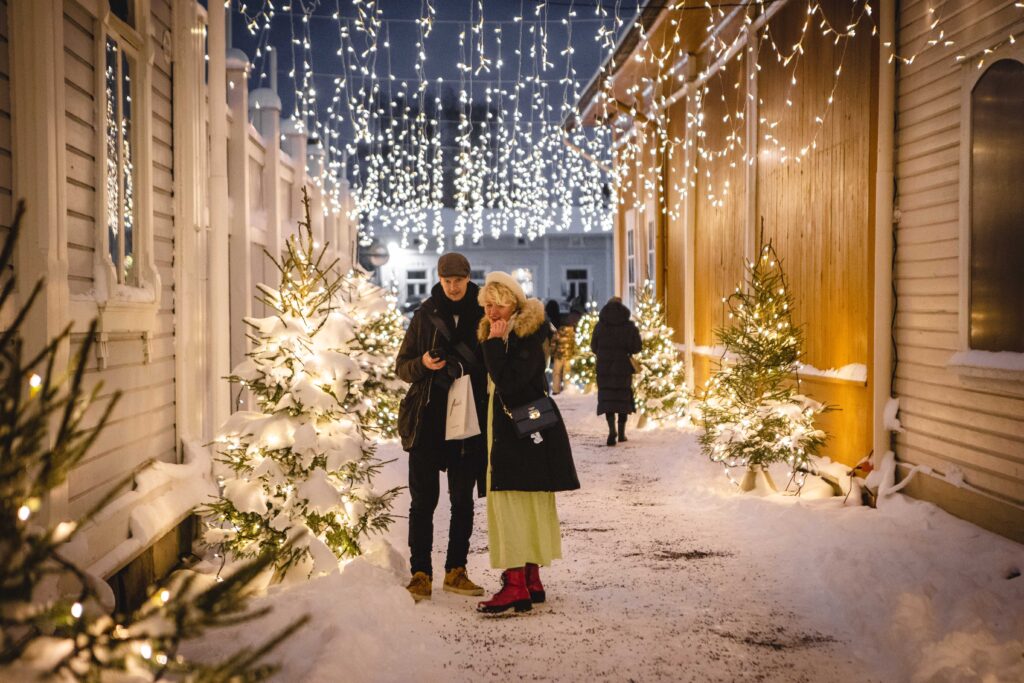 A couple at the Christmas tree alley in Vähäraastuvankatu.