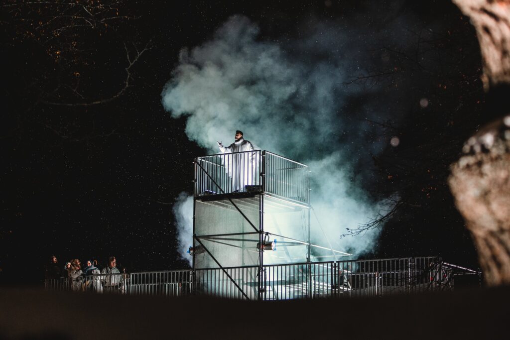 A person performing on a high stage.