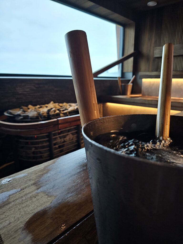 A bucket full of water in sauna.